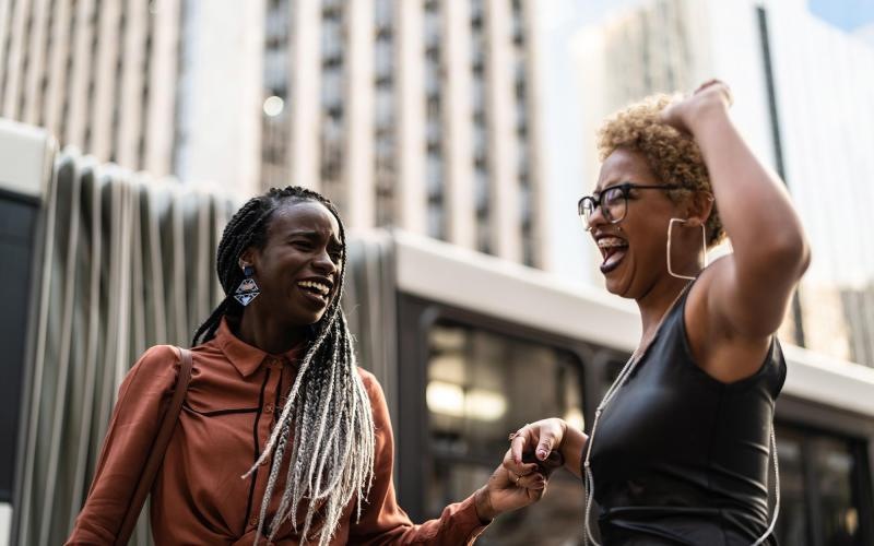 women laughing together in the city