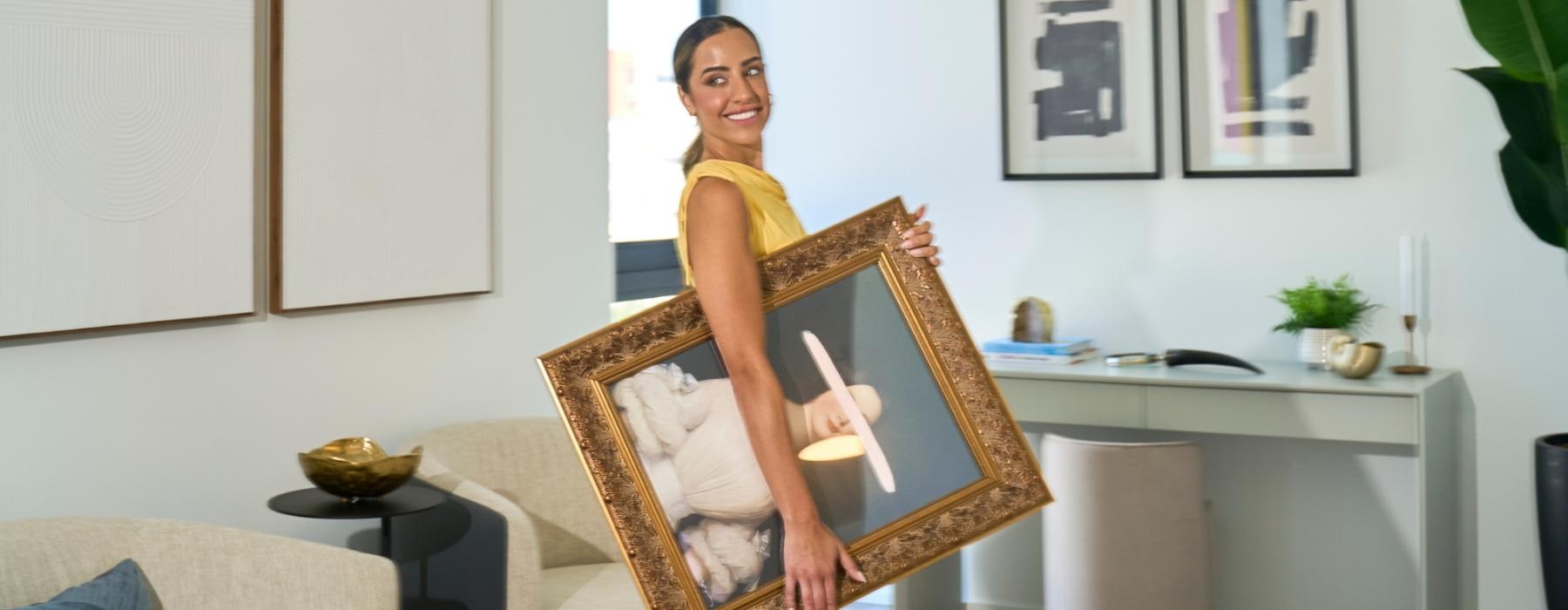 a person holding a picture frame