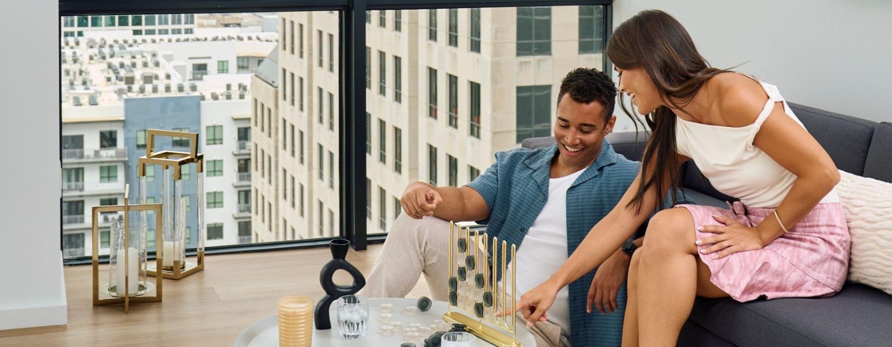 a man and woman sitting on a couch playing a game